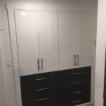 White and black modern wardrobe with drawers.