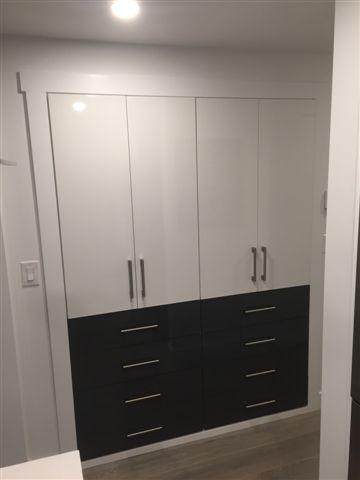 White and black modern wardrobe with drawers.
