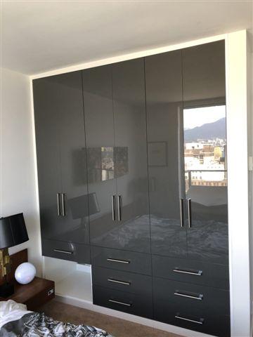 Gray wall-mounted wardrobe with glossy finish.